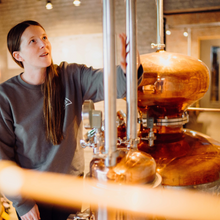 Lead distiller at In The Welsh Wind Distillery working with one of the copper pot stills which is used to create our distinctive Welsh spirits in small batches.