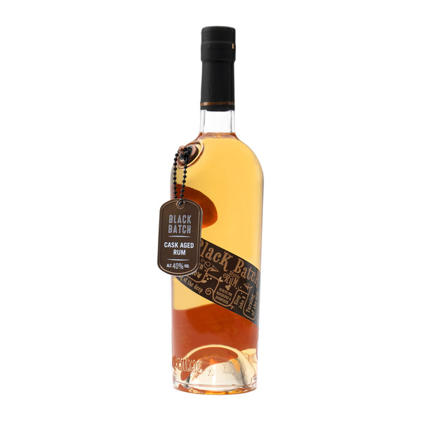 A 70cl bottle of Eccentric Spirit Co's Black Batch Cask Aged Welsh Rum with a white background. Our Welsh spiced rum has a signature dog tag dangling from the bottle and a distinctive black and brown label, which tells the story of what inspired the Welsh rum's creation.