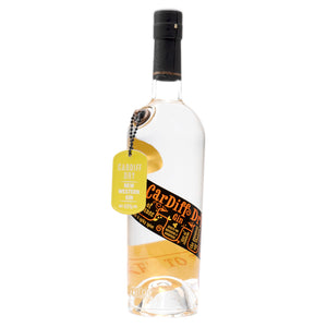 A 70cl bottle of Eccentric Spirit Co's Cardiff Dry Welsh Gin with a white background. This Welsh gin has a yellow dog tag dangling from the bottle and a distinctive orange, yellow and black label, which screams of the Welsh city that this Welsh gin was distilled in honour of.