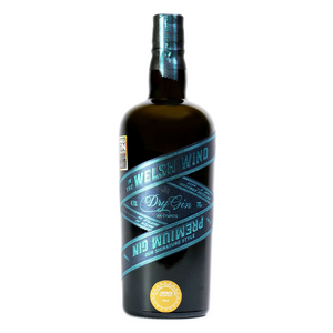 A 70cl bottle of Signature Style Gin by In The Welsh Wind Distillery with a white background. This Welsh dry gin, in a glass bottle, has a beautiful and unique blue label and won Best Gin Label Design and a Gold Medal at the World Gin Awards 2021.
