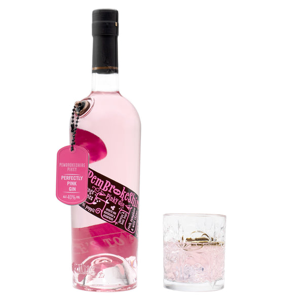 A 70cl bottle of Eccentric Spirit Co's Pembrokeshire Pinky Welsh Gin alongside an old fashioned glass half-filled with the Welsh pink gin.