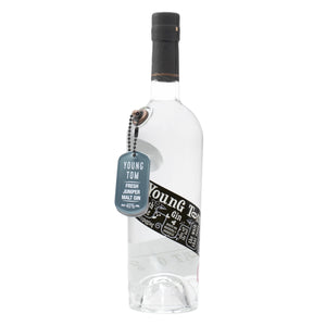 A 70cl bottle of Eccentric Spirit Co's Young Tom Gin with a white background. This Welsh gin has a distinctive dog tag dangling from the bottle and a black and white label, which screams of the inspiration behind this Welsh gin.